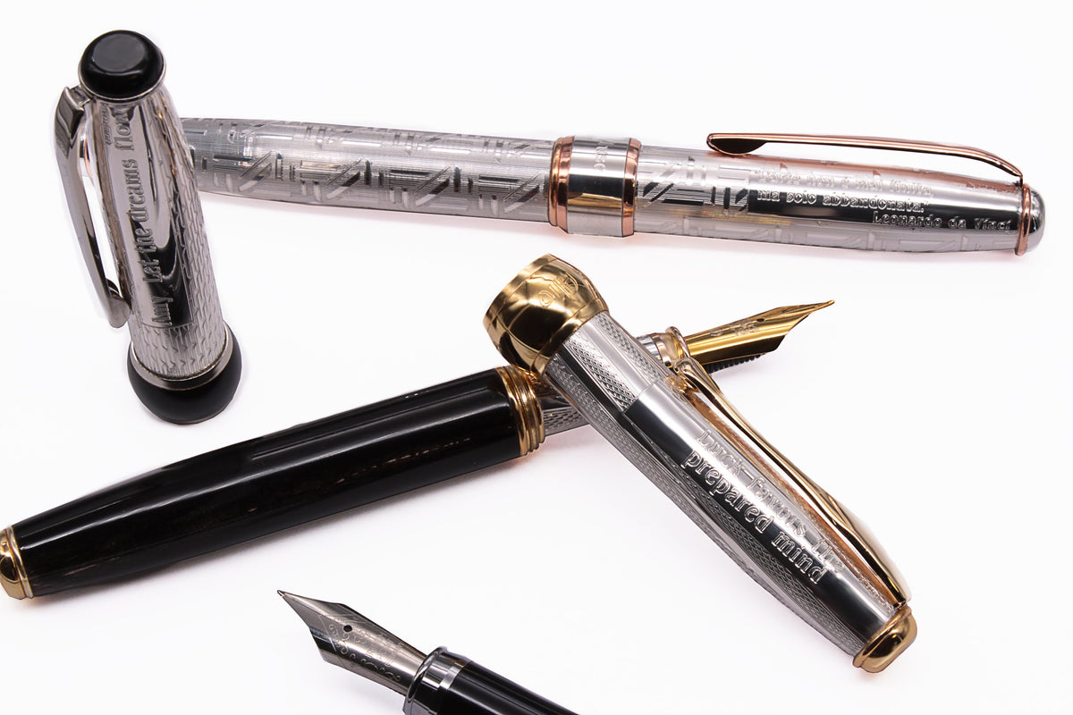 Silver pens with names and dedications engraved on the barrel and cap
