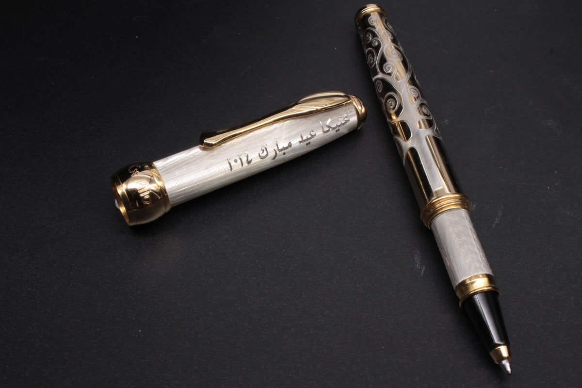 Silver rollerball with an Arabic dedication engraved on the cap