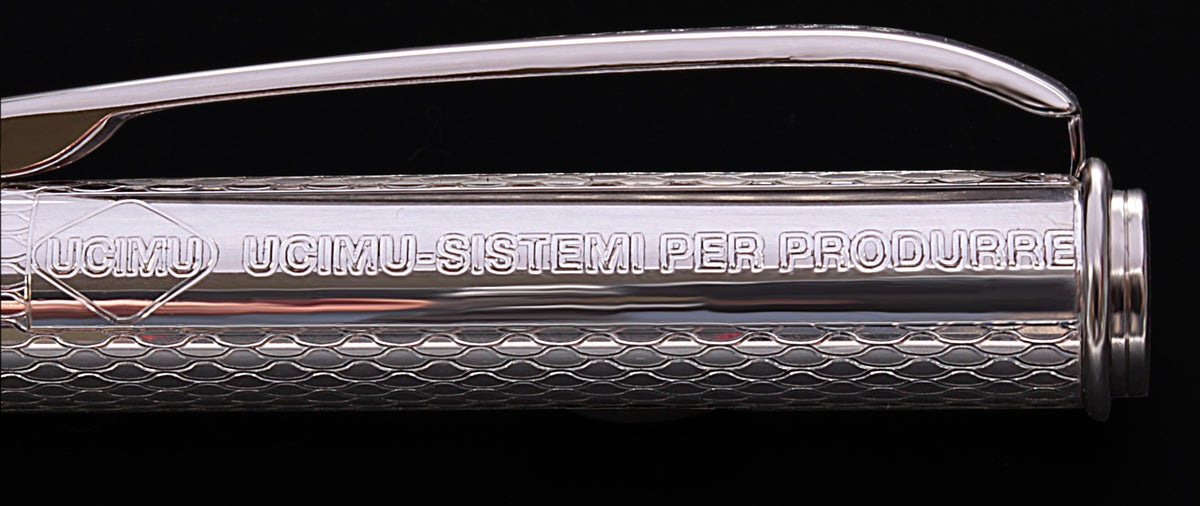 Company name engraved in the window next to the clip of a silver pen