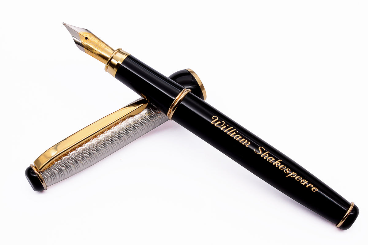 Black fountain pen with gold nib and trim, with the name William Shakespeare engraved on the barrel