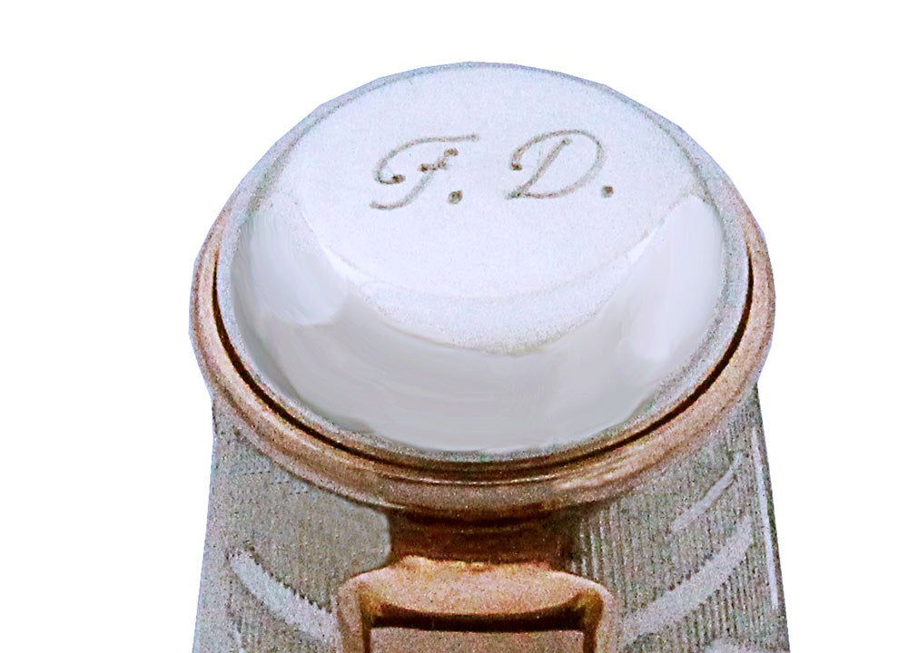 Initials F.D. engraved on the top of a pen cap